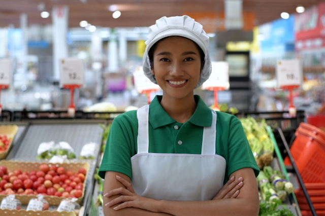 Female grocery store worker smiling