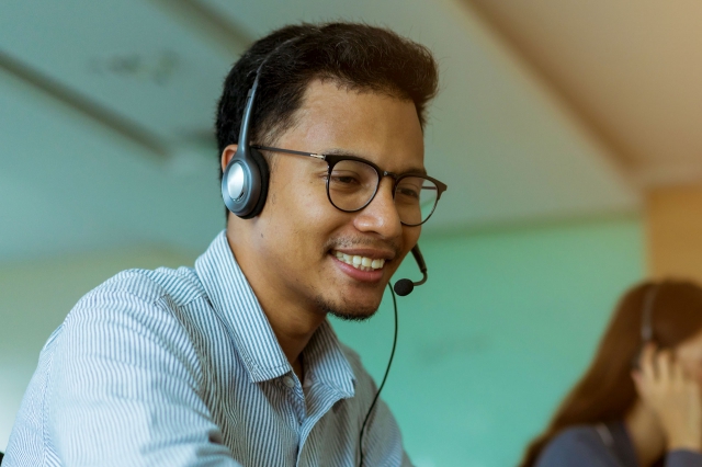Call center agent talking over his headset